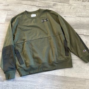 Army green, Champion crew-neck sweatshirt. Pocket in front goes across.